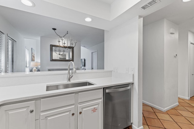 kitchen with dishwasher, an inviting chandelier, white cabinets, sink, and light tile patterned flooring