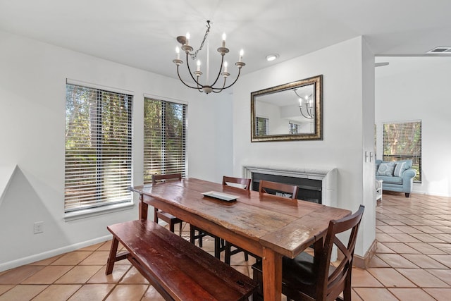 tiled dining area with an inviting chandelier