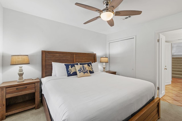 tiled bedroom with a closet and ceiling fan