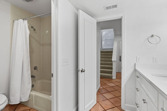 bathroom with tile patterned floors, shower / bath combo with shower curtain, and vanity