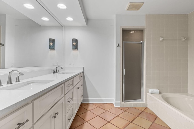 bathroom featuring shower with separate bathtub, vanity, and tile patterned floors