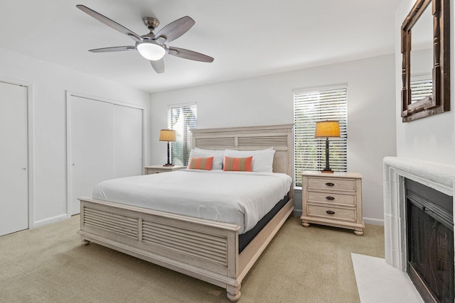 bedroom featuring ceiling fan and light colored carpet