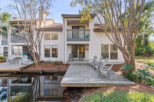 back of house featuring a deck