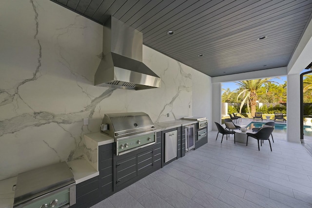 view of patio / terrace with exterior kitchen and a grill