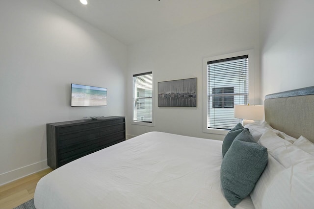 bedroom with lofted ceiling and hardwood / wood-style floors