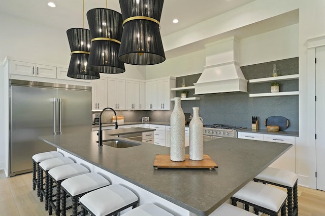 kitchen with white cabinets, backsplash, stainless steel appliances, and custom range hood