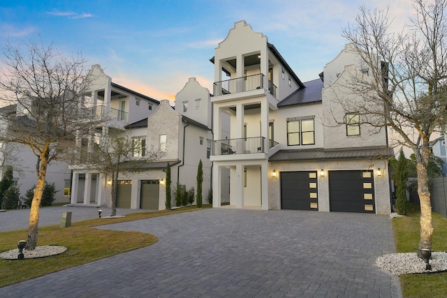 view of front of property with a balcony and a garage