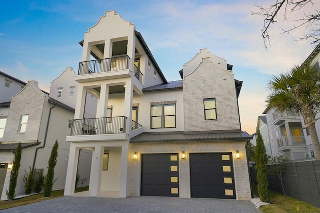 view of front of house featuring a balcony and a garage