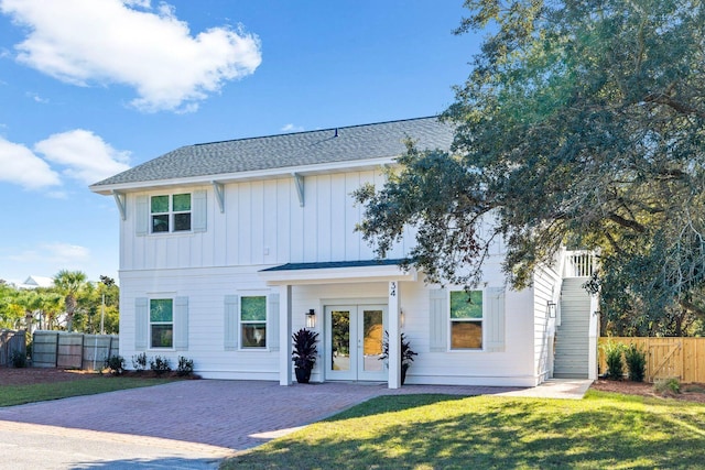 view of front of property with a front lawn and french doors