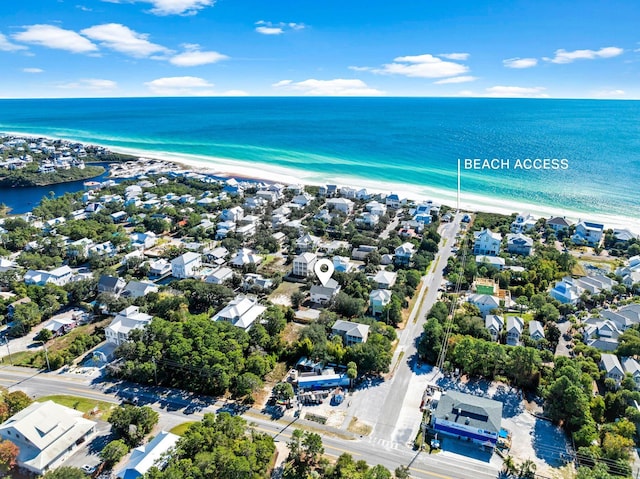 birds eye view of property with a beach view and a water view