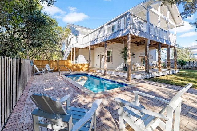 view of swimming pool with a patio and a wooden deck