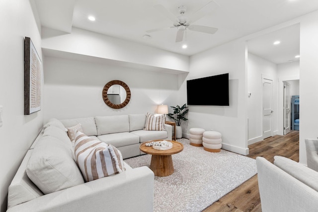 living room with ceiling fan and wood-type flooring