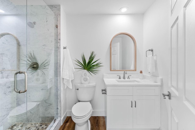34 Buddy St, Santa Rosa Beach, FL 32459 - bathroom featuring toilet, vanity, a marble finish shower, wood finished floors, and baseboards
