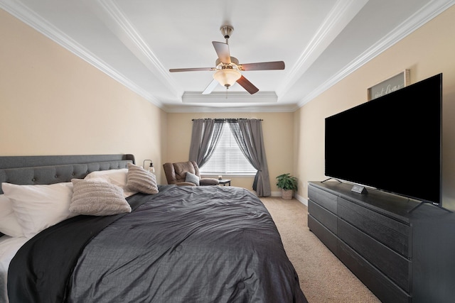 bedroom featuring ornamental molding, light colored carpet, ceiling fan, and a tray ceiling