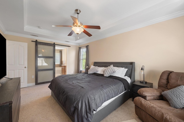 bedroom featuring crown molding, ceiling fan, a barn door, a tray ceiling, and light colored carpet