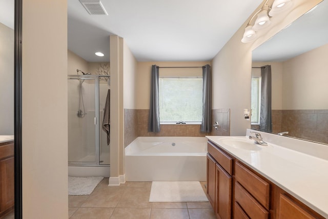 bathroom with tile patterned flooring, vanity, and separate shower and tub