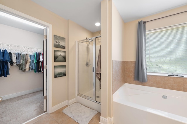 bathroom with separate shower and tub and tile patterned floors