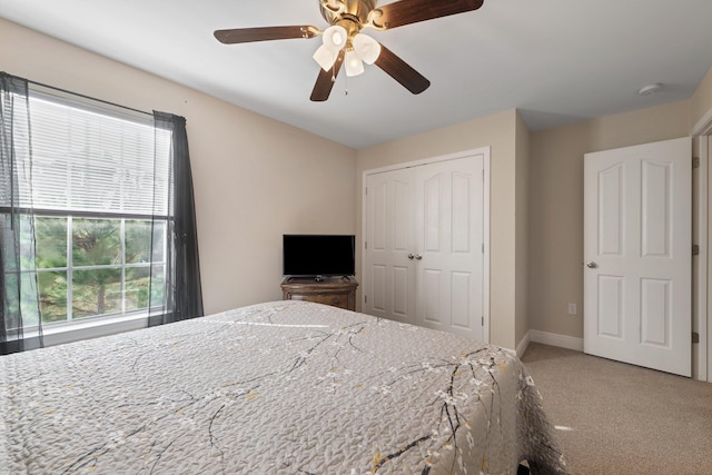 bedroom with carpet flooring, multiple windows, ceiling fan, and a closet