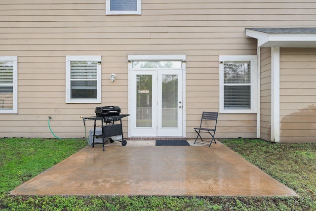 view of exterior entry featuring french doors and a patio