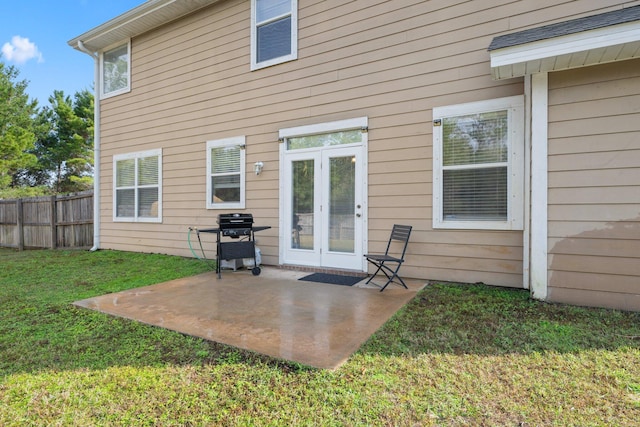 back of house with a lawn, a patio, and french doors