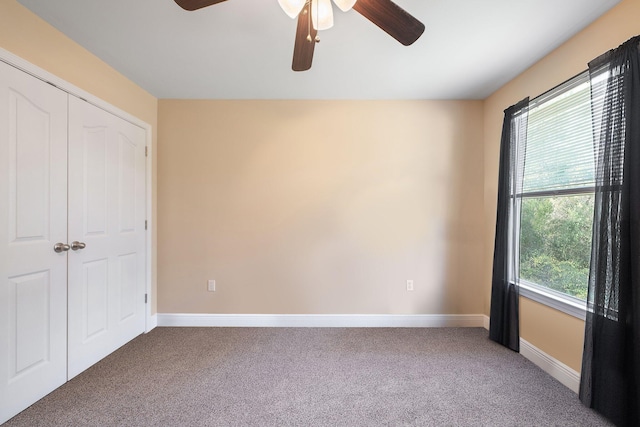 unfurnished bedroom featuring carpet floors, multiple windows, and ceiling fan