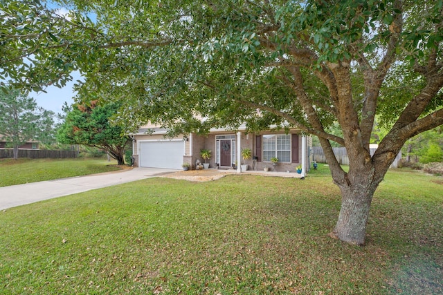 view of property hidden behind natural elements featuring a front yard and a garage