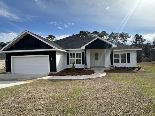 view of front of home featuring a garage and a front lawn