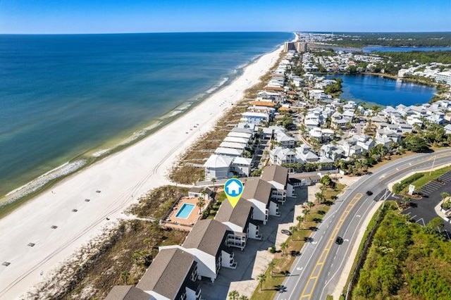 drone / aerial view featuring a water view and a view of the beach