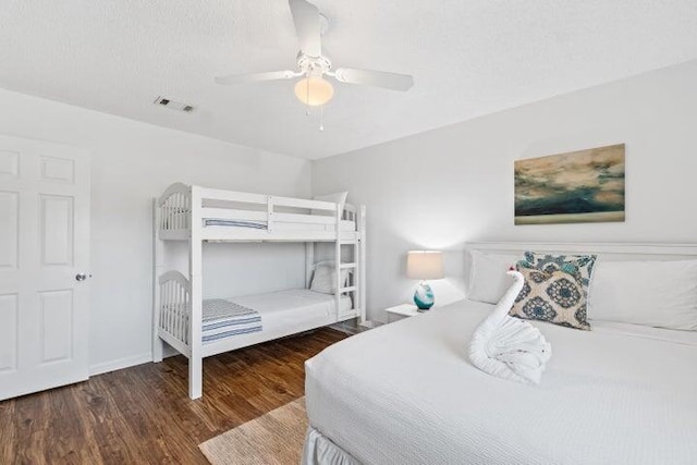 bedroom featuring ceiling fan and dark wood-type flooring