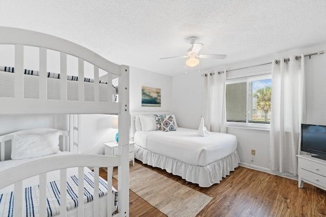 bedroom featuring ceiling fan, a textured ceiling, and hardwood / wood-style flooring