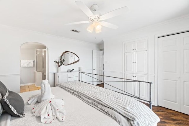 bedroom with ceiling fan, crown molding, and dark hardwood / wood-style floors