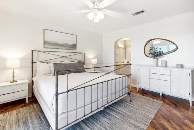 bedroom with dark hardwood / wood-style floors, ceiling fan, and crown molding