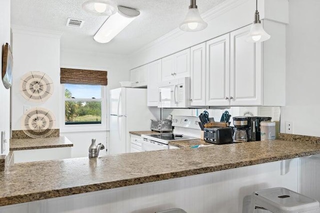 kitchen featuring ornamental molding, a textured ceiling, white appliances, white cabinets, and hanging light fixtures