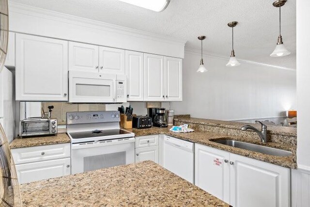 kitchen featuring white cabinets, white appliances, decorative light fixtures, and sink