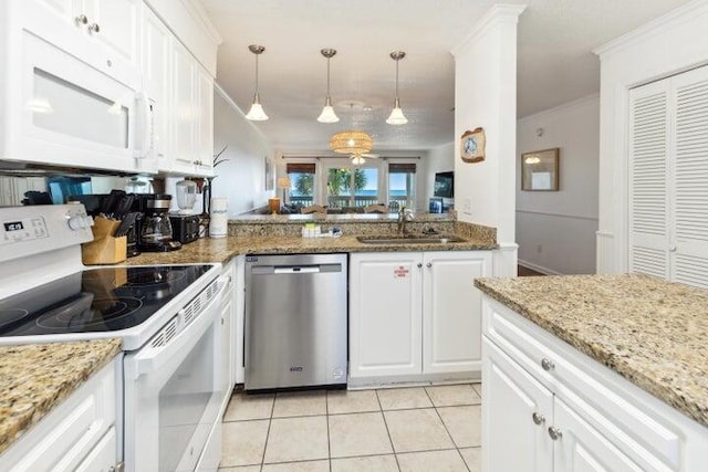 kitchen featuring white cabinets, pendant lighting, light tile patterned flooring, and white appliances