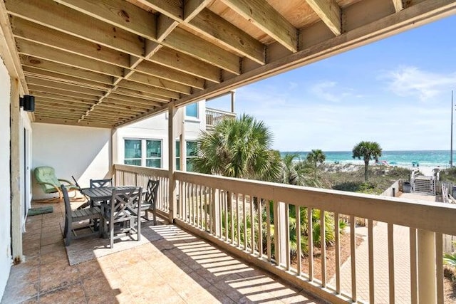 balcony with a view of the beach and a water view