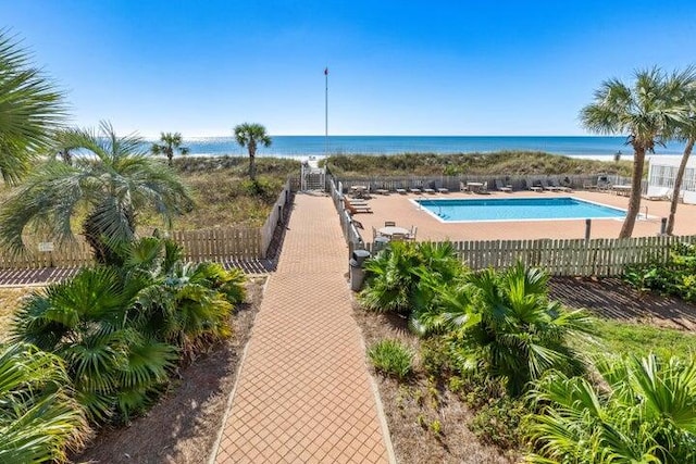 view of swimming pool featuring a water view