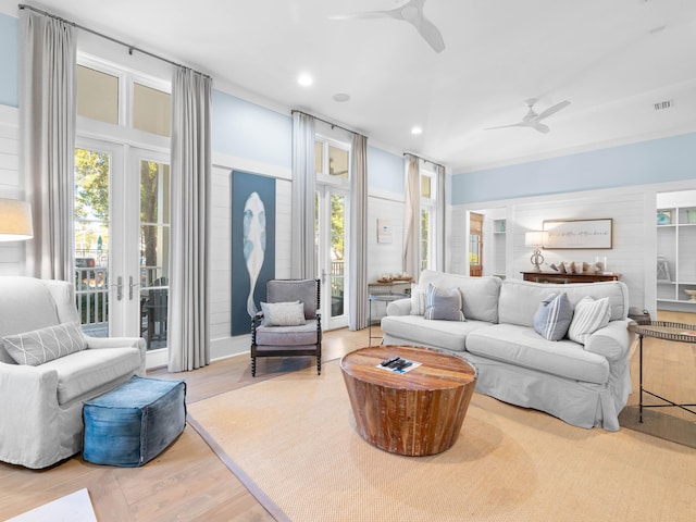 living room with ceiling fan, light hardwood / wood-style floors, and french doors