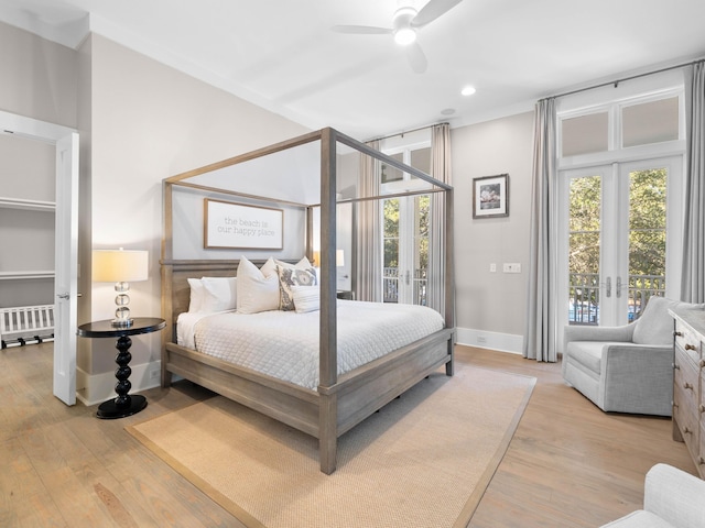 bedroom featuring radiator, ceiling fan, french doors, and light hardwood / wood-style floors