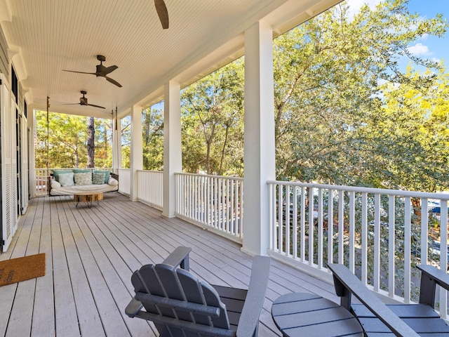 wooden deck featuring outdoor lounge area and ceiling fan