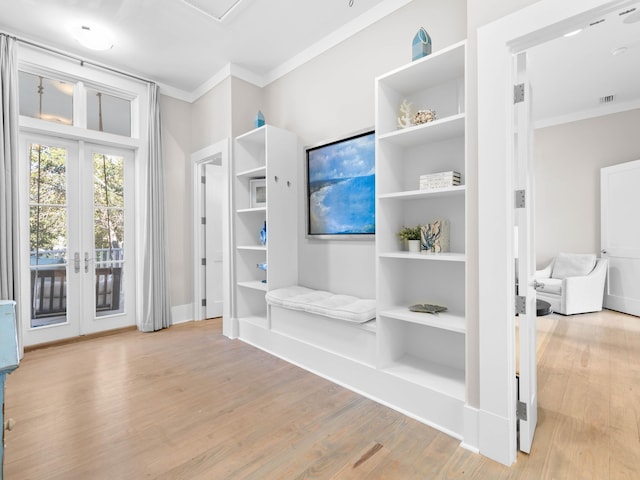 interior space featuring french doors, light hardwood / wood-style flooring, and ornamental molding