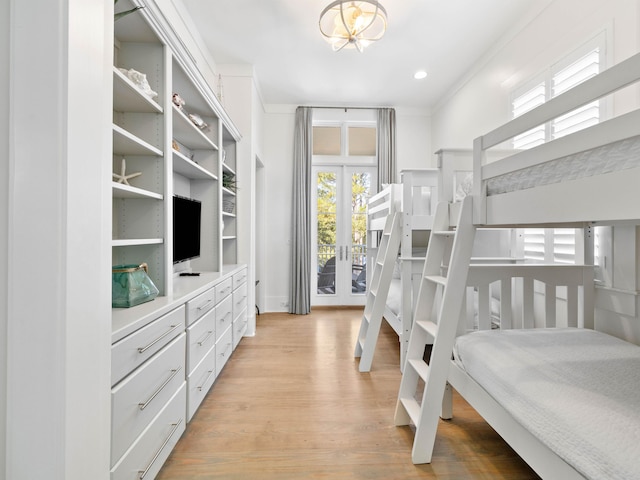 bedroom featuring access to exterior, french doors, light hardwood / wood-style floors, and crown molding