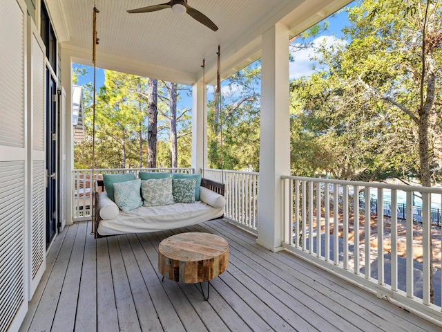 wooden terrace with ceiling fan and an outdoor hangout area