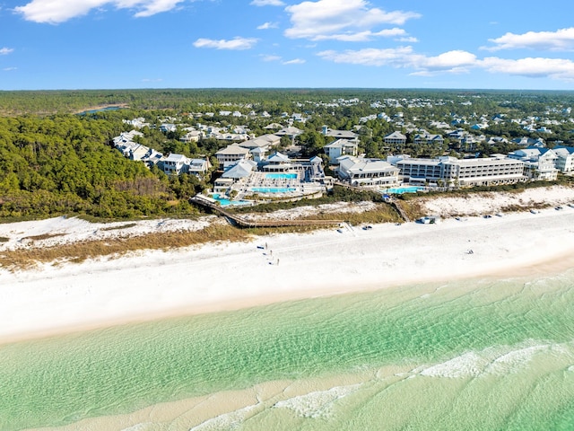 birds eye view of property with a water view and a beach view