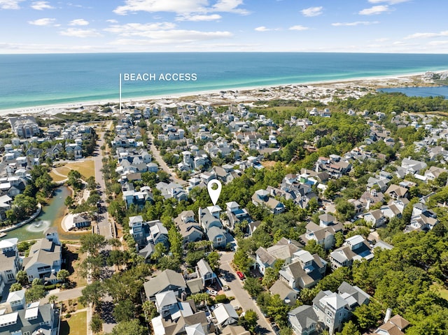 bird's eye view with a water view and a beach view