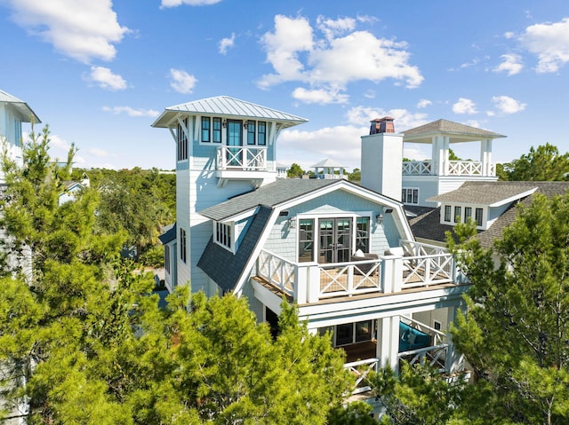 back of house featuring a balcony