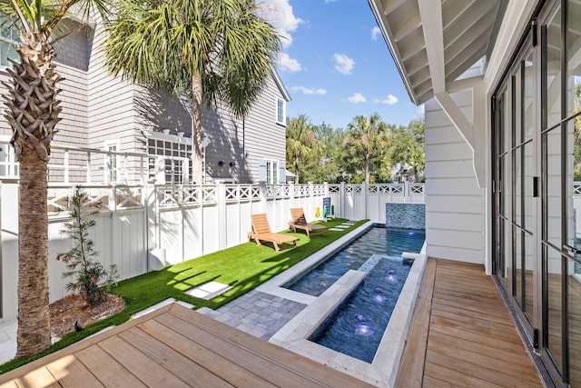 deck with a swimming pool with hot tub