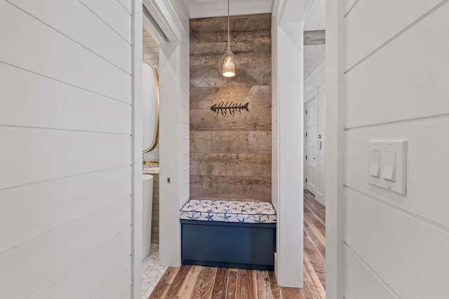 mudroom featuring hardwood / wood-style floors and wood walls