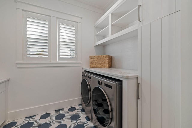 laundry room with light tile patterned floors, separate washer and dryer, and crown molding