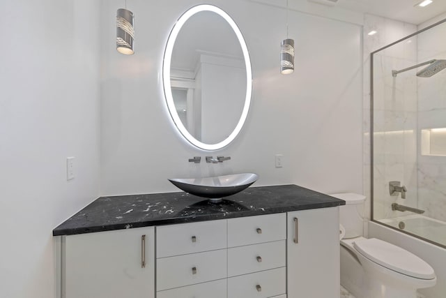 full bathroom featuring vanity, toilet, ornamental molding, and bath / shower combo with glass door